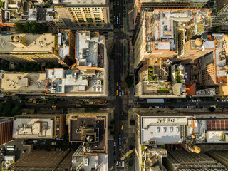 Aerial top down view of New York downtown street intersection. Manhattan buildings with yellow cabs and cars