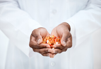 Hand, pills and doctor holding medicine for cancer treatment closeup in a medical clinic. Supplements, vitamins and antibiotics capsule or pill for medicare with open hand of pharmacist
