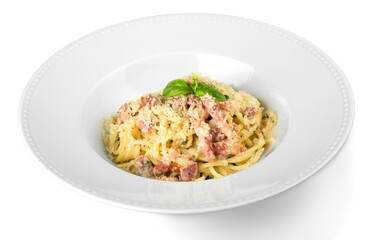 Close-up of tasty pasta with basil in white plate isolated on white background