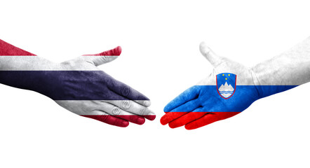 Handshake between Slovenia and Thailand flags painted on hands, isolated transparent image.