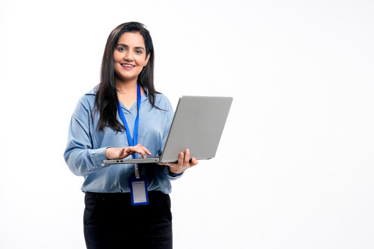 Indian businesswoman or employee using laptop on white background.