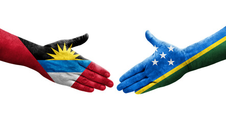 Handshake between Solomon Islands and Antigua Barbuda flags painted on hands, isolated transparent image.