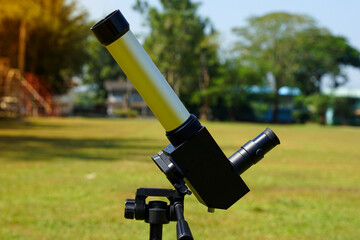 sun telescope set on the lawn in the school that the teacher has prepared for students to observe...