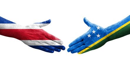 Handshake between Solomon Islands and Costa Rica flags painted on hands, isolated transparent image.