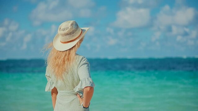 Woman enjoying Mediterranean beach sounds