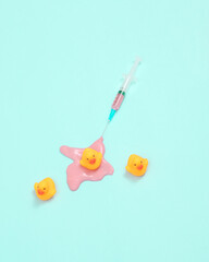 Creative minimalist layout. syringe with ducks on pinkbackground. Surreal medicine idea. Conceptual pop