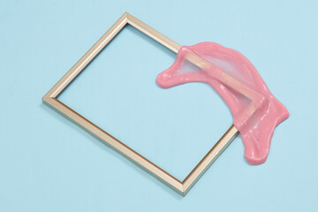 Creative minimalist layout. Frame with slime on a blue background. Surreal summer idea. Conceptual...