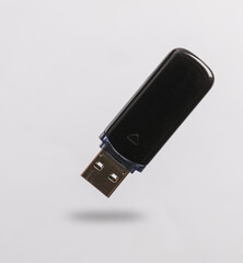 Usb flash drive levitating on gray background with shadow