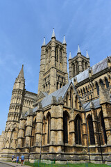 Fototapeta na wymiar landscape of Lincoln cathedral in summer with blue sky . Double central towers of cathedral in gothic style.the yellow cathedral from brick