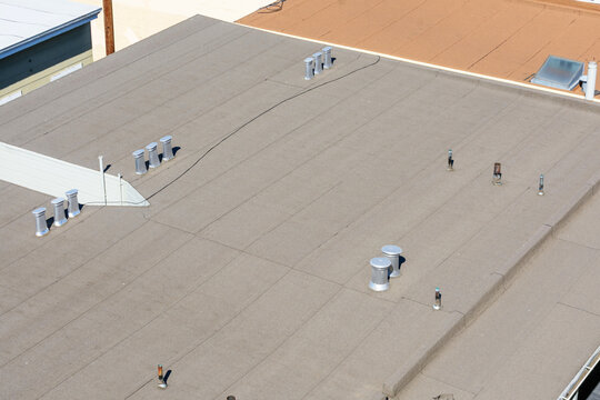 Vent, exhaust pipes on flat roof of a building