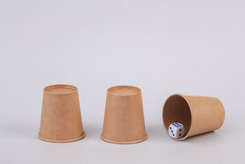 Gambling with cups. Dice under the cup