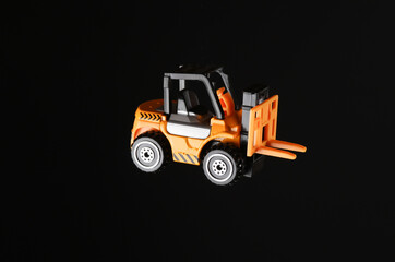 Toy forklift isolated on black background