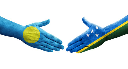 Handshake between Solomon Islands and Palau flags painted on hands, isolated transparent image.