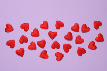 Lots of red hearts on a purple background. Love concept