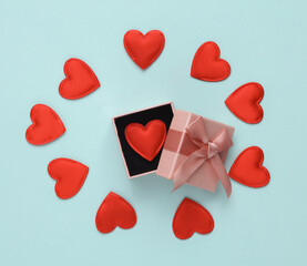 Gift box with hearts on a blue background. Romantic, love, valentine's day concept