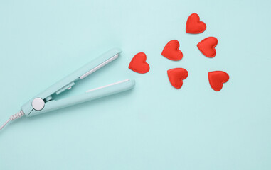 Hair iron with hearts on a blue background