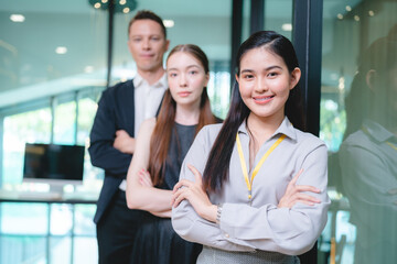 Obraz premium Young Asian business man in formal clothing showing something on digital tablet to senior female boss and manager wearing eyeglasses while in a meeting and training on technology