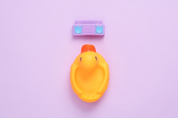 Rubber duck with boombox recorder on purple background. Music concept