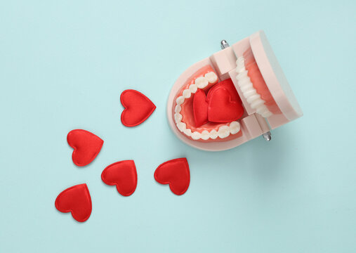 Human jaw with hearts on gray background. Love, romance, valentine's day, February 14 concept