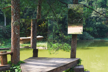 Creative idea with cube mirrors on trees in pine forest against lake in Da Lat Vietnam