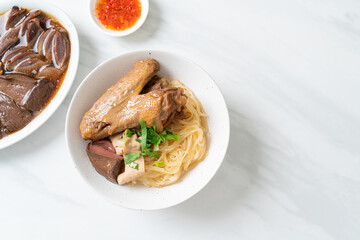 dried noodles with braised duck in white bowl