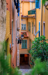 Traditional old terracotta houses on a narrow street in the Old Town of Villefranche sur Mer on the French Riviera, South of France