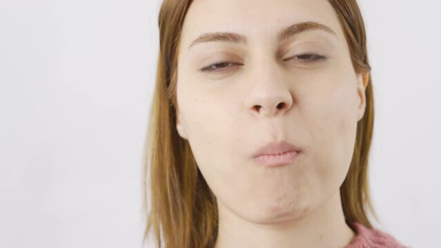 Woman eating chocolate dragee in close-up. Chocolate.
Close-up woman eats chocolate balls.
