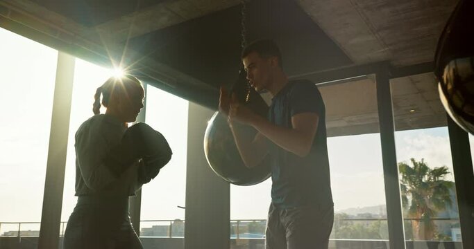 Fitness, woman and boxer high five with personal trainer for training, exercise or practice workout at the gym. Man coaching female in sports boxing for competition, self defense or fighting match