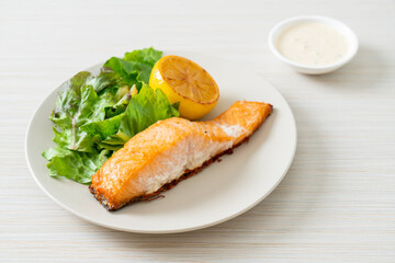 fried salmon steak with lemon and vegetable
