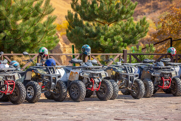 ATVs in the parking lot are rented in the recreation area. Quad bike and equipment. Extreme Entertainment. Kazakhstan, Shymkent - October 17, 2022 © Vera