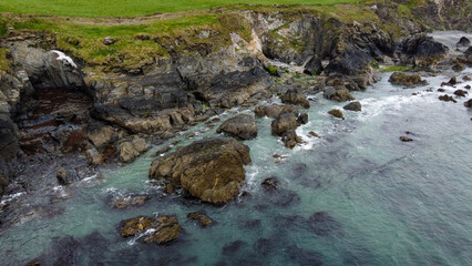 Tidal waves of the Atlantic Ocean near the southern coast of the island of Ireland. Rocky seashore. Seascape, top view. View from above.
