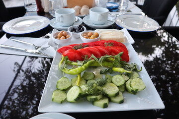 Traditional Turkish Breakfast with vegetables cucumber, tomatoes, green chilli on the plate