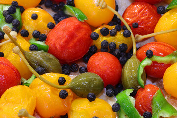 mediterranean products  yellow and red cherry tomatoes and capers