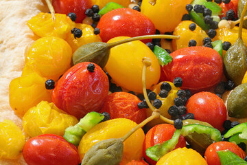 mediterranean products  yellow and red cherry tomatoes and capers