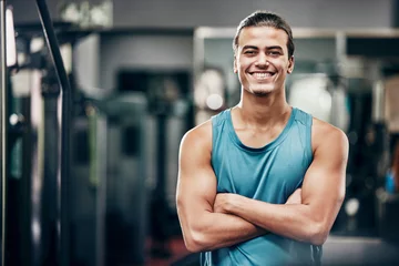 Fotobehang Personal trainer in gym, portrait of man from healthy lifestyle and fitness motivation of strong guy in Mexico. Confident mexican coach, training body goals with workout and wellness strength trainer © Beaunitta V W/peopleimages.com