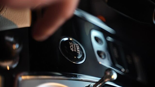 42 Finger presses the start button of the car vertical