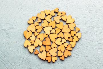 defocused wooden golden little small heart shape scattered chaotic or placed in big heart form,round circle or at image edge.lot of stack wood love sign.valentine's day February 14th celebration 