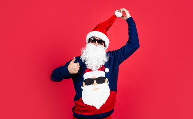 happy bearded man in santa claus hat and knitted sweater show thumb up celebrate new year winter holiday, new year party