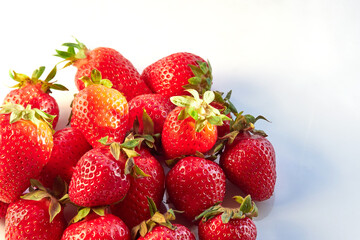 Fresh, red and delicious strawberries on a light background