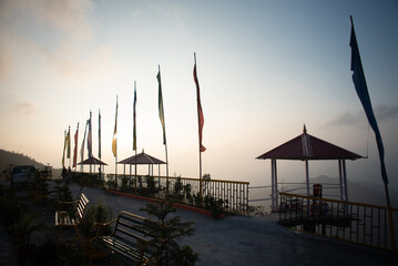 Buddhist flags placed on top of a hill