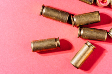 Casings and cartridges on red background.