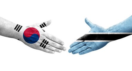 Handshake between South Korea and Botswana flags painted on hands, isolated transparent image.