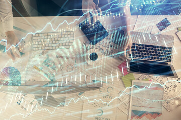 Multi exposure of man and woman working together and financial chart hologram. Business concept. Computer background.