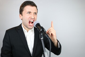 Naklejka premium Angry politician Man talking in the Microphone 