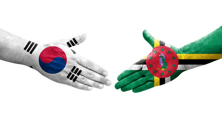 Handshake between South Korea and Dominica flags painted on hands, isolated transparent image.