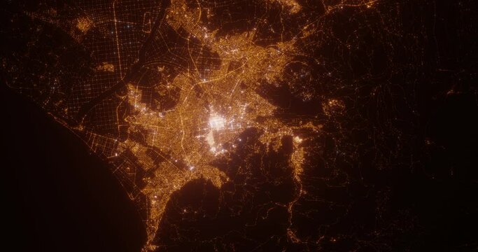 Sapporo (Japan) top view at night. Aerial view on modern city from space. Camera is flying above the city, moving forward. Vertical video. The north is on the left side