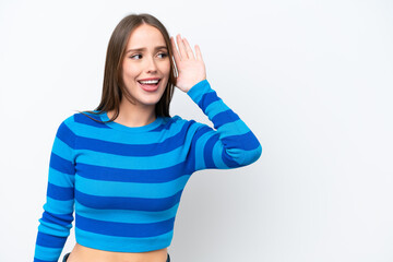 Fototapeta premium Young pretty caucasian woman isolated on white background listening to something by putting hand on the ear