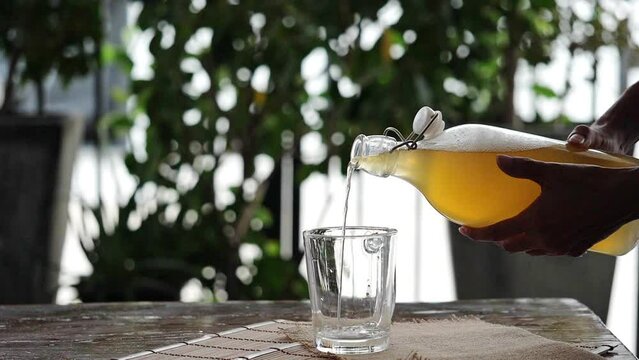 Fermented tea in a glass and bottle, Concept. Kombucha Healthy fermented tea.