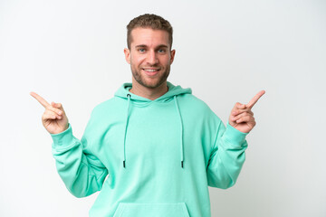 Young handsome caucasian man isolated on white background pointing finger to the laterals and happy