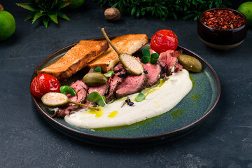 Italian food Vitello tonnato, sliced tuna, capers, tomatoes, sauce, fried toast.